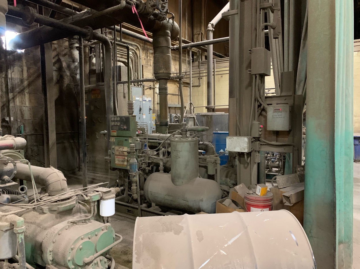 The aging compressed air system: dusty equipment with tangled piping, over 30 years old